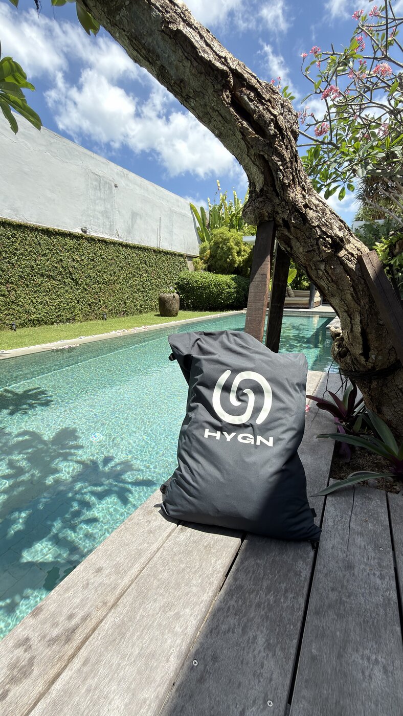 HYGN bag packed and ready beside a pool deck